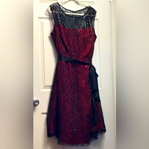 Never worn. Red and black semi formal sleeveless dress.